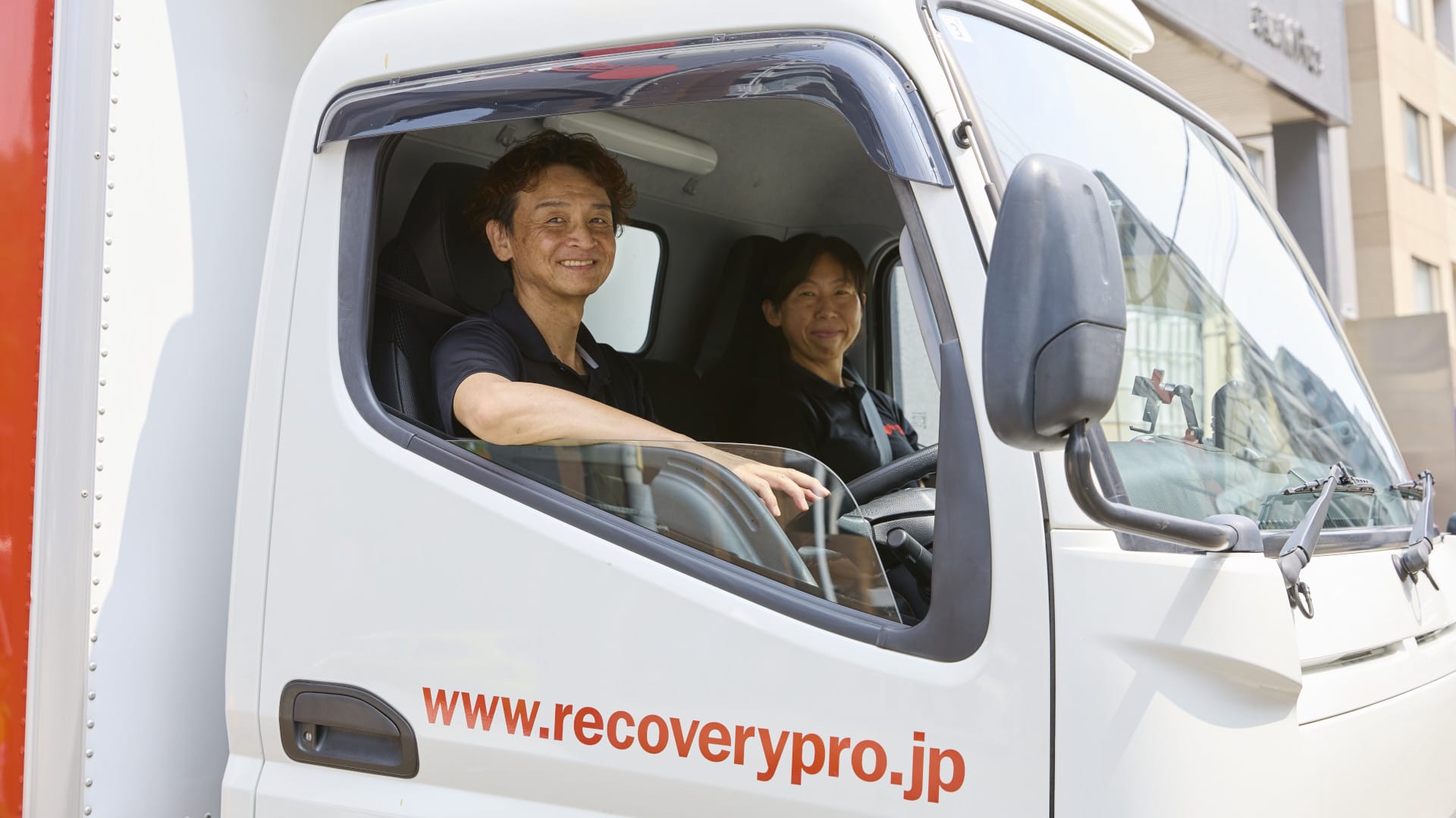 Two colleagues sitting in a lorry