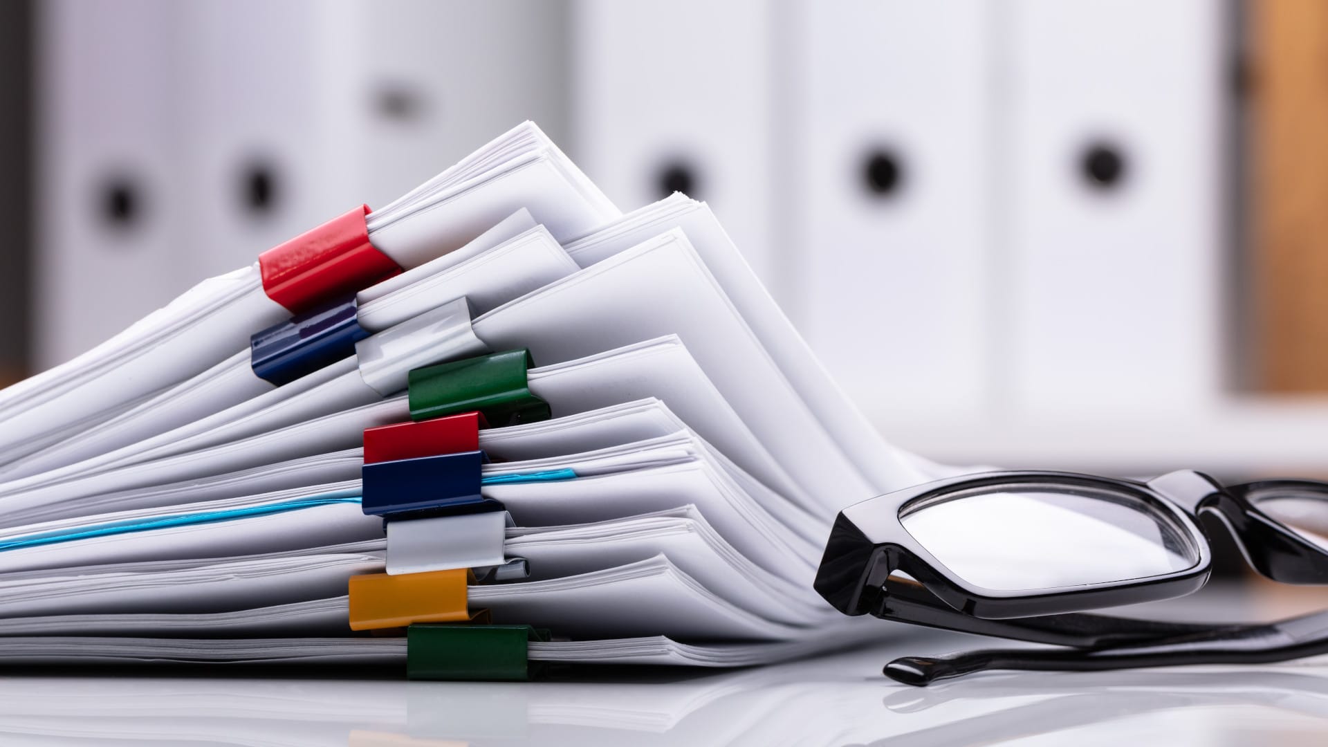 Stacked Documents And Eyeglasses
