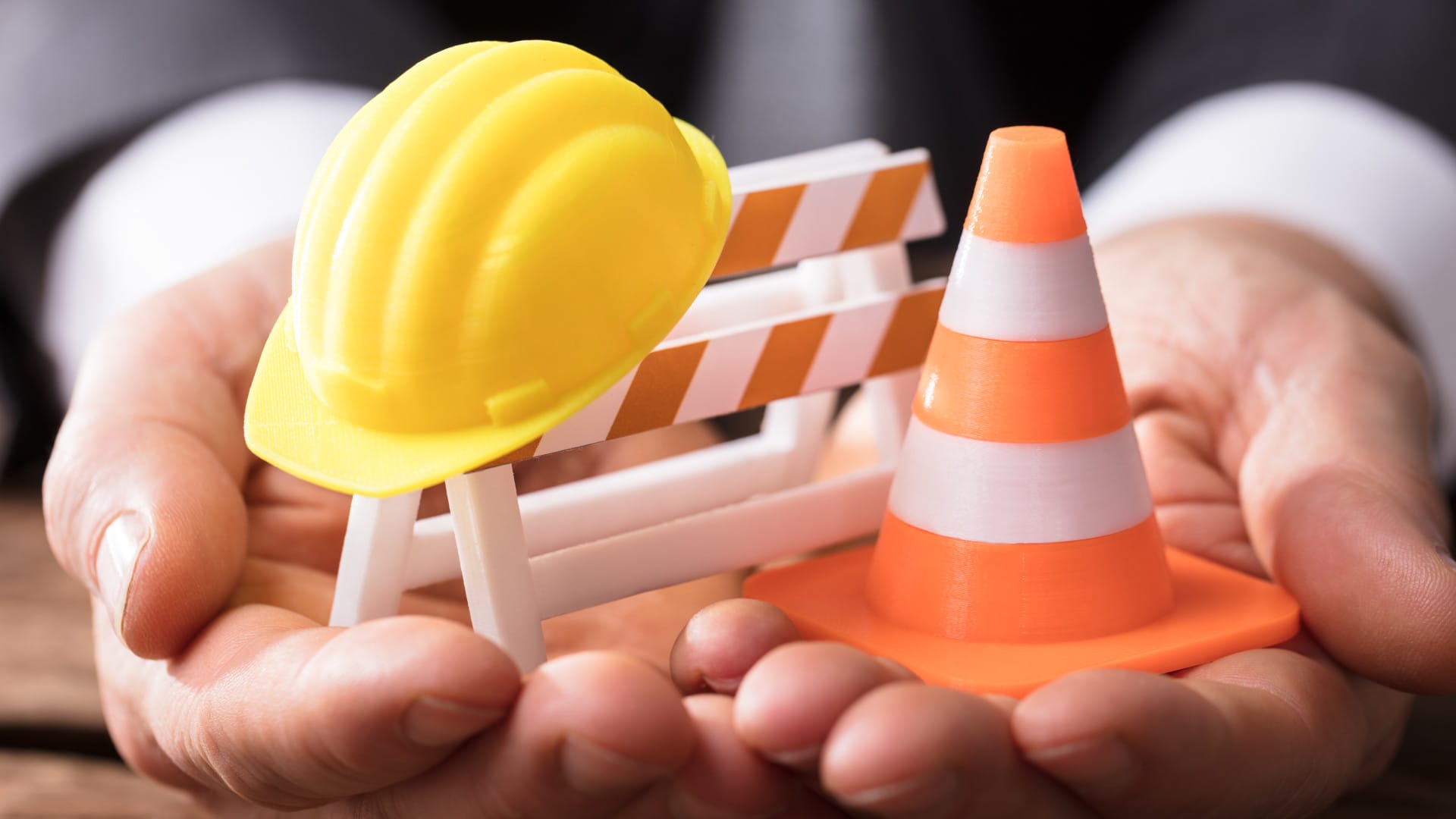 Close-up Of Barricade With Traffic Cone And Hard Hat